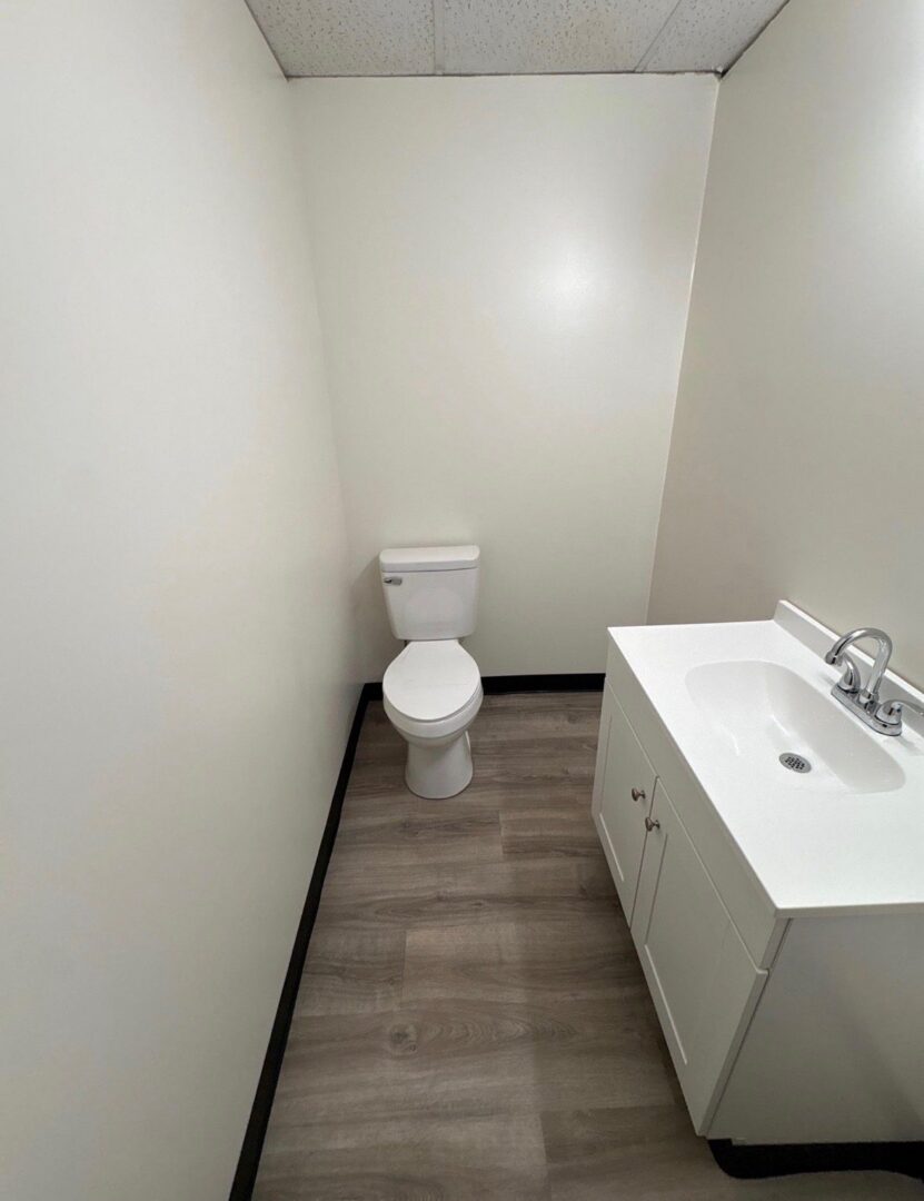 Finished bathroom with a white vanity and new flooring