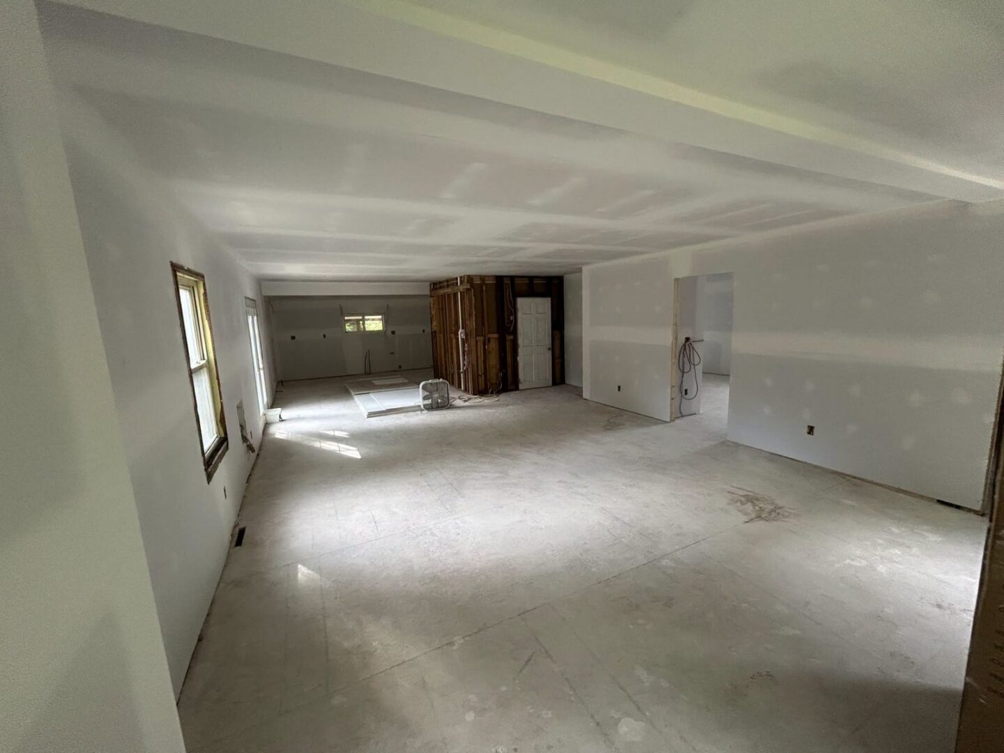 Large open commercial space with new drywall hung