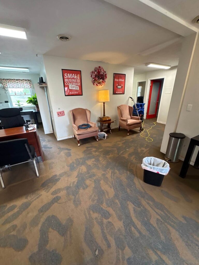 Flood mud and silt on office carpet during commercial flood cleanup in July 2026