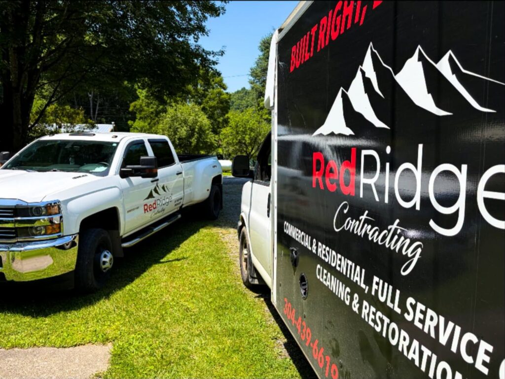 Red Ridge Contracting pickup and branded box truck ready for a restoration job
