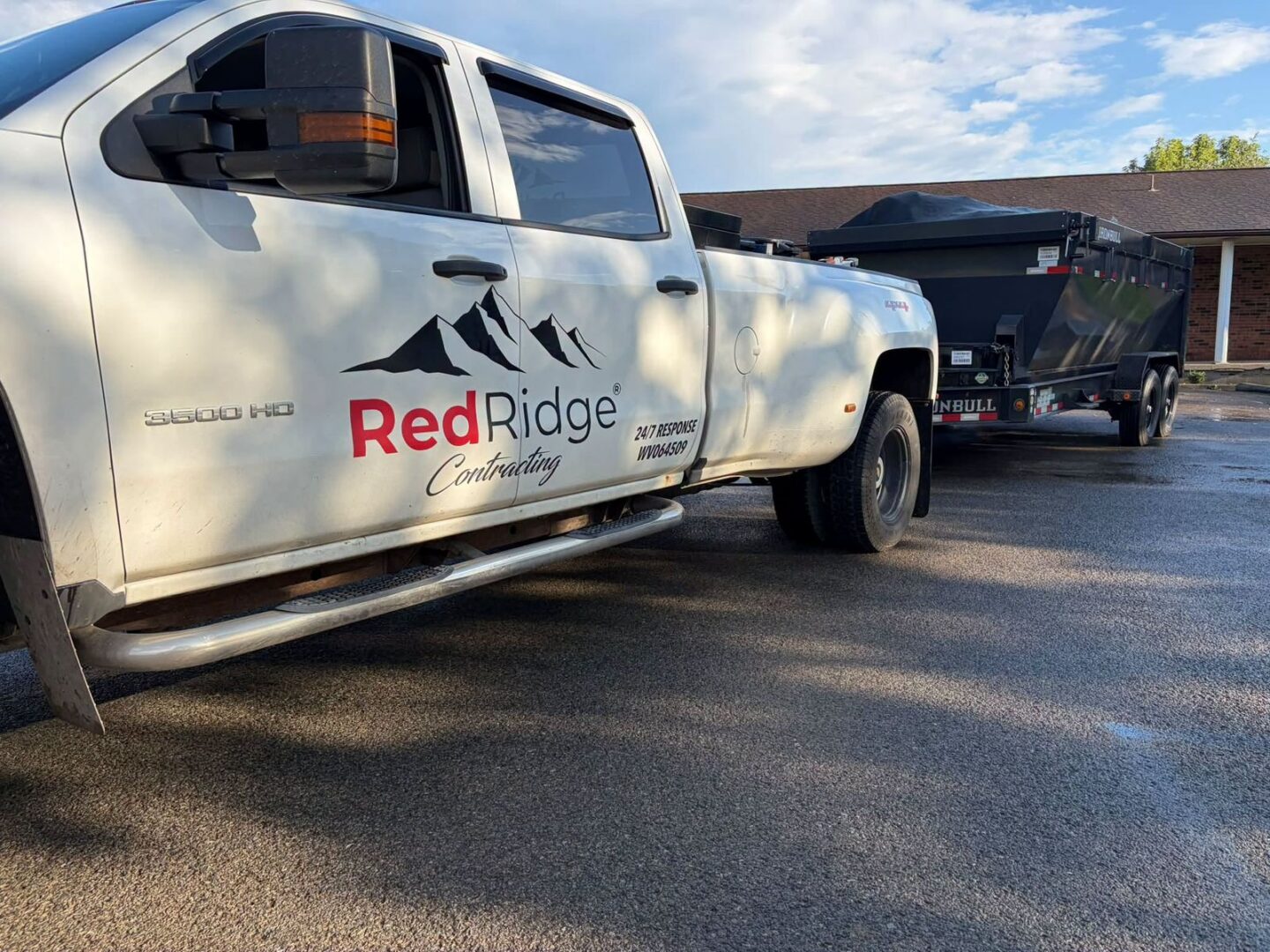 Red Ridge Contracting truck and dump trailer on a local restoration job
