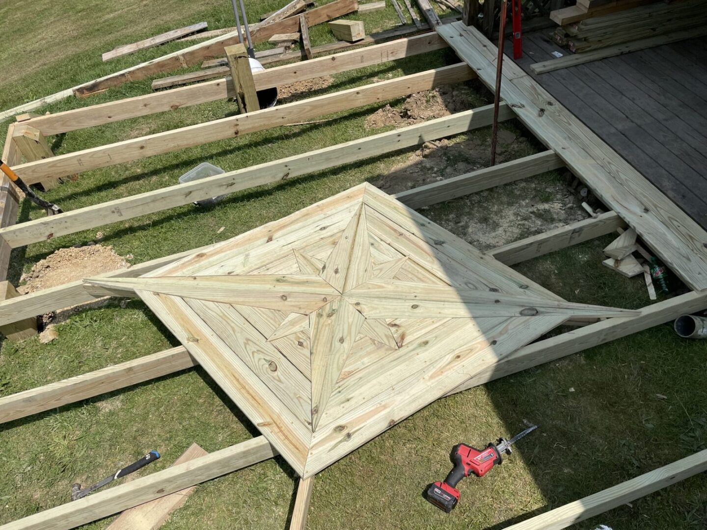 Deck framing with diamond-pattern decking being installed