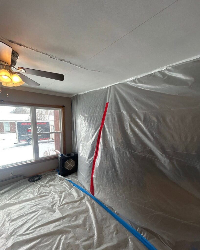 Plastic containment and HEPA air scrubber set up for mold remediation in a West Virginia home