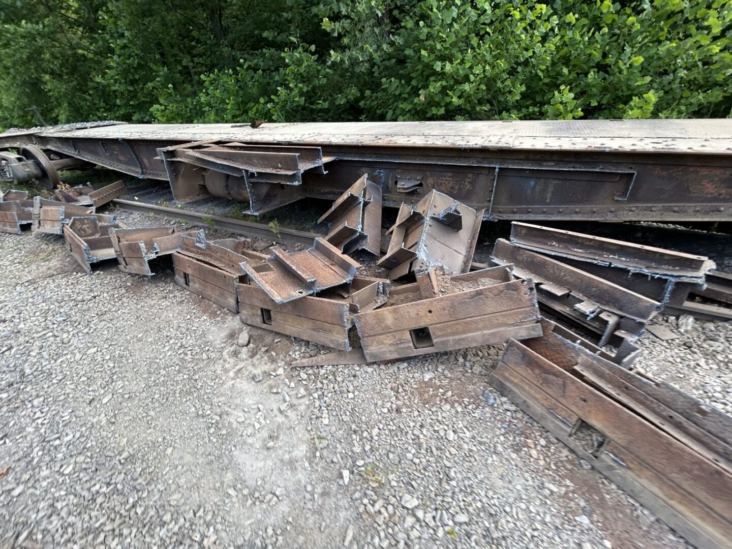 Pile of dismantled steel on gravel at a job site